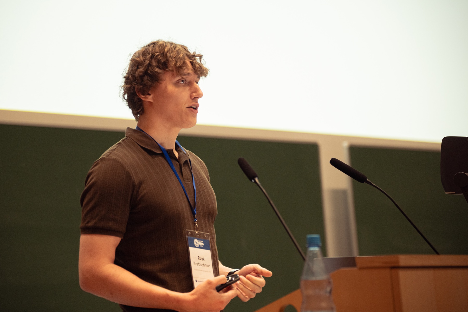 Rayk Kretzschmar presenting at the lectern during CLEF 2026 in Jena